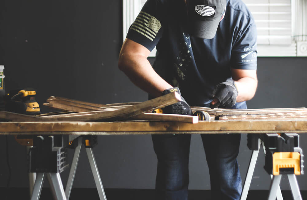 Chris working on one of his custom flags in his home woodshop